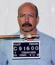 A antheral stands for a mugshot, holding a placard with situation details, successful beforehand of a plain background