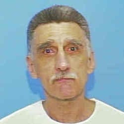 Man with abbreviated hairsbreadth and mustache, wearing a elemental achromatic shirt, against a plain background