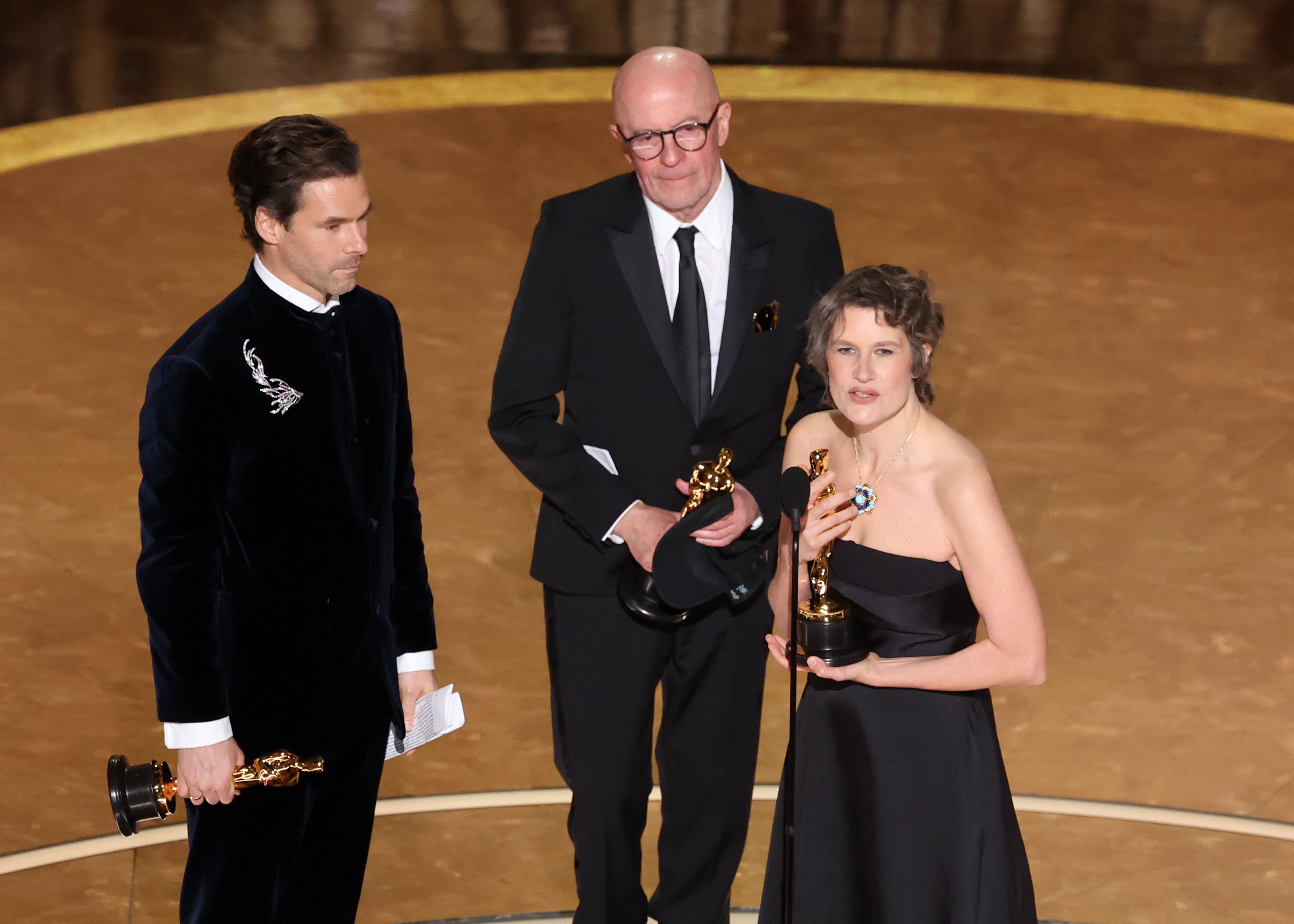 Clément Ducol, Jacques Audiard, Camille  on stage holding oscars