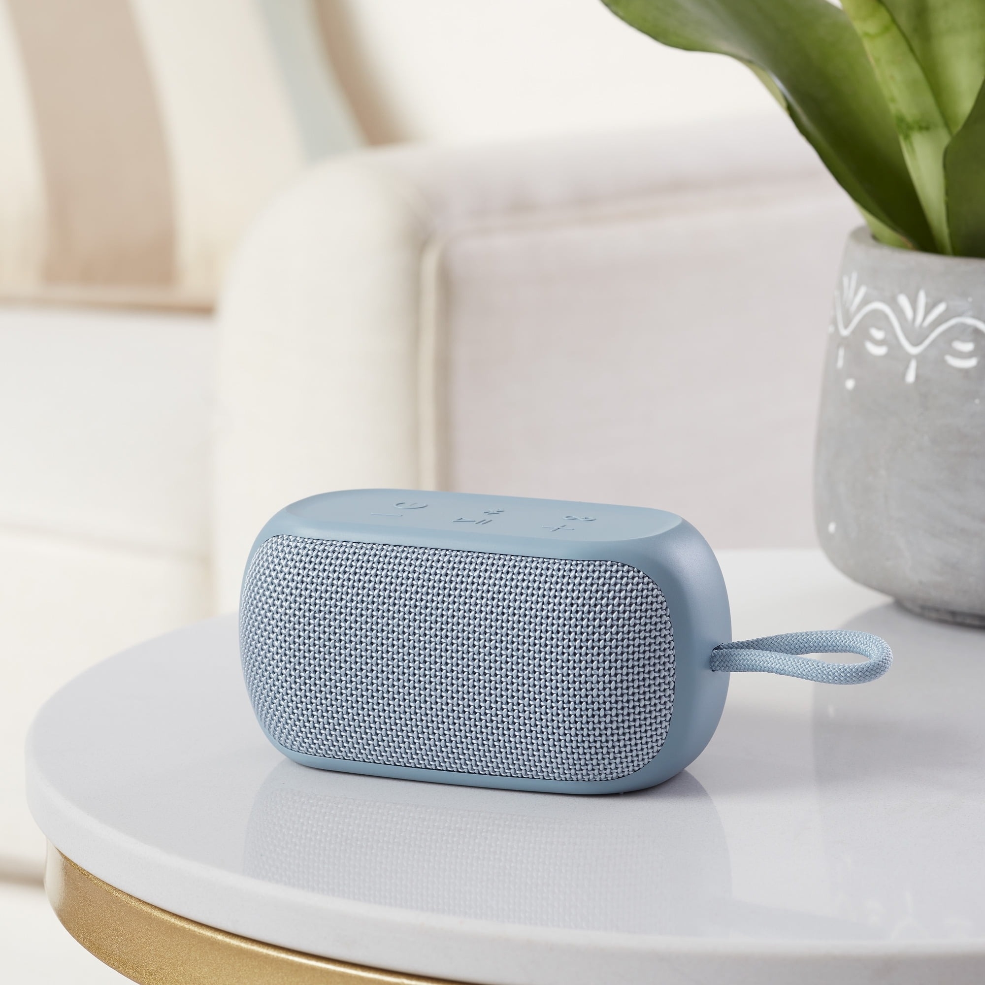 Compact portable speaker with and strap in light blue