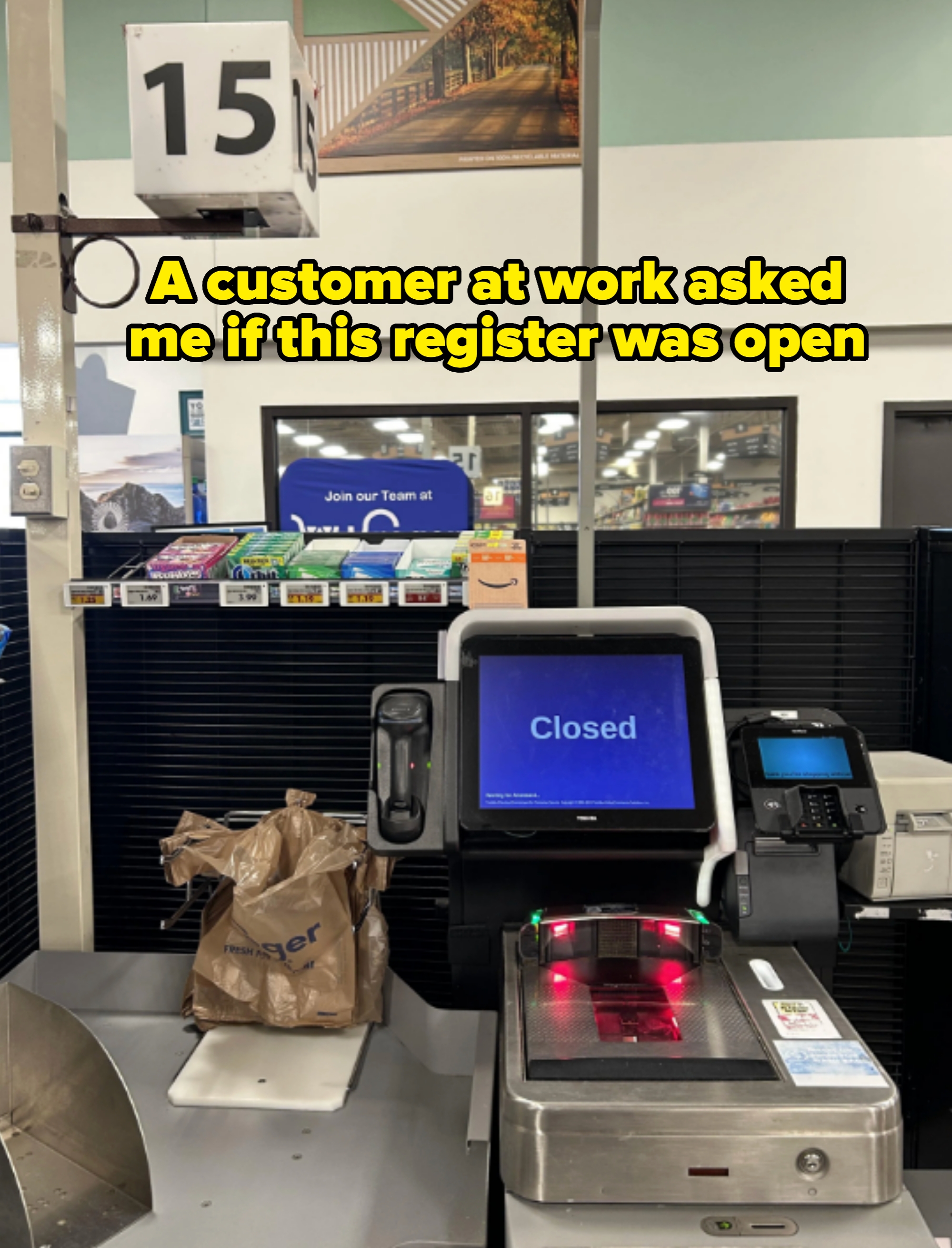 A self-checkout station with a "Closed" sign displayed on the screen, containing a bag with groceries and a closed register sign above