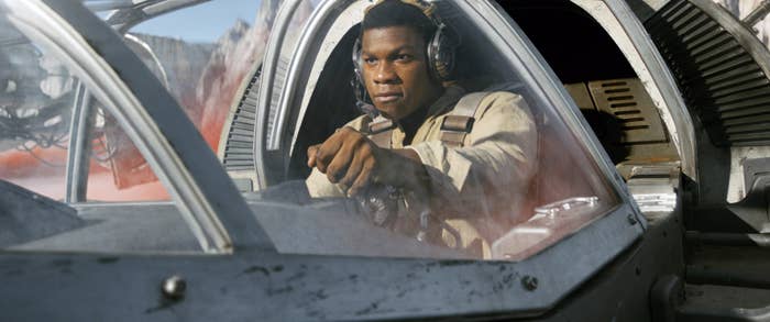 Person in a sci-fi spaceship cockpit, wearing a flight suit and headphones, focused on piloting the vessel