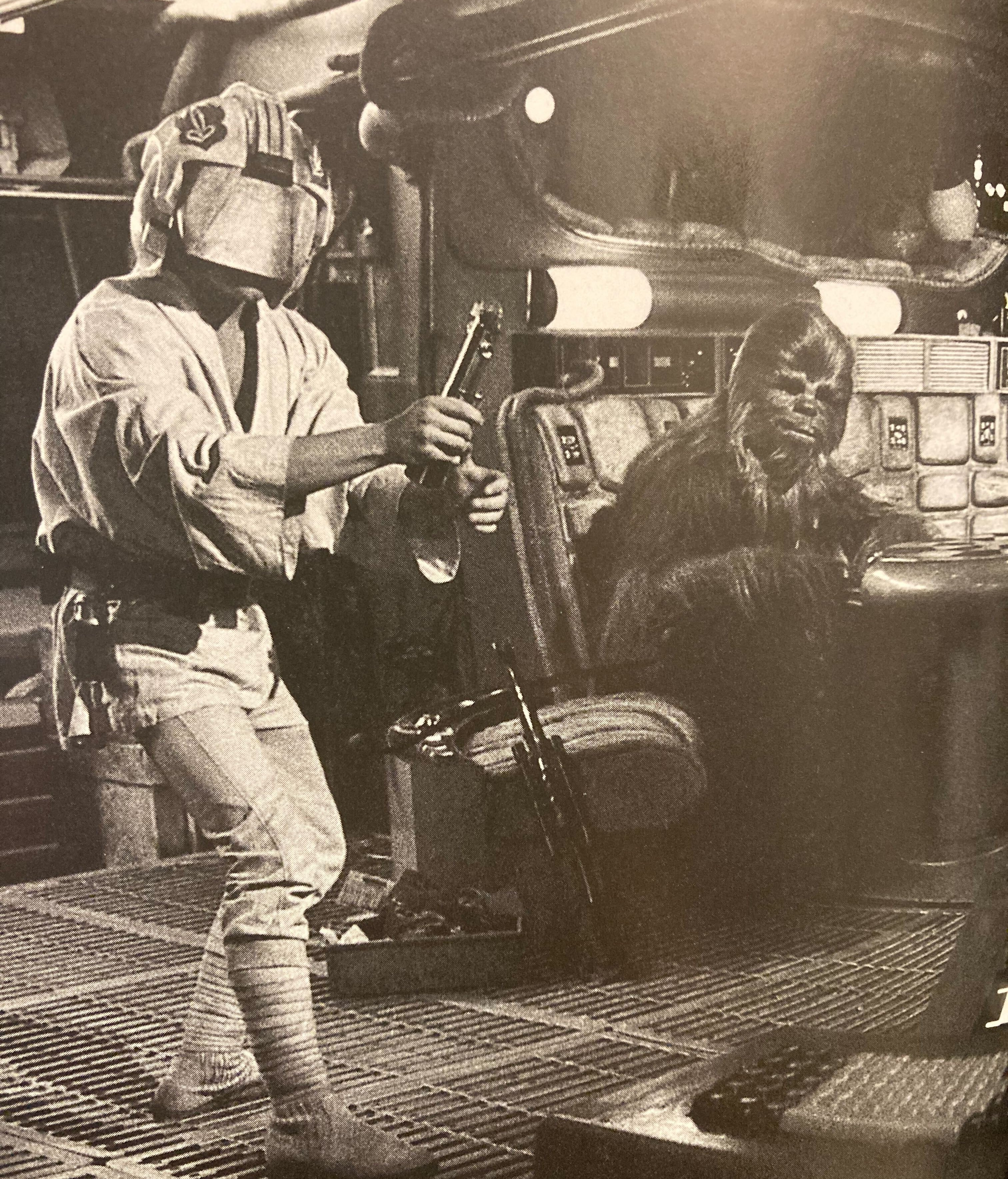 Two characters from Star Wars: one with a helmet and sword, the other resembling Chewbacca, in a spaceship cockpit setting