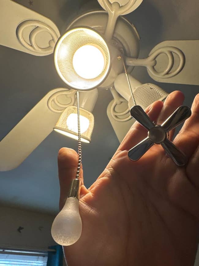 Hand pulls ceiling instrumentality   concatenation  with airy  bulb and instrumentality   leaf  design