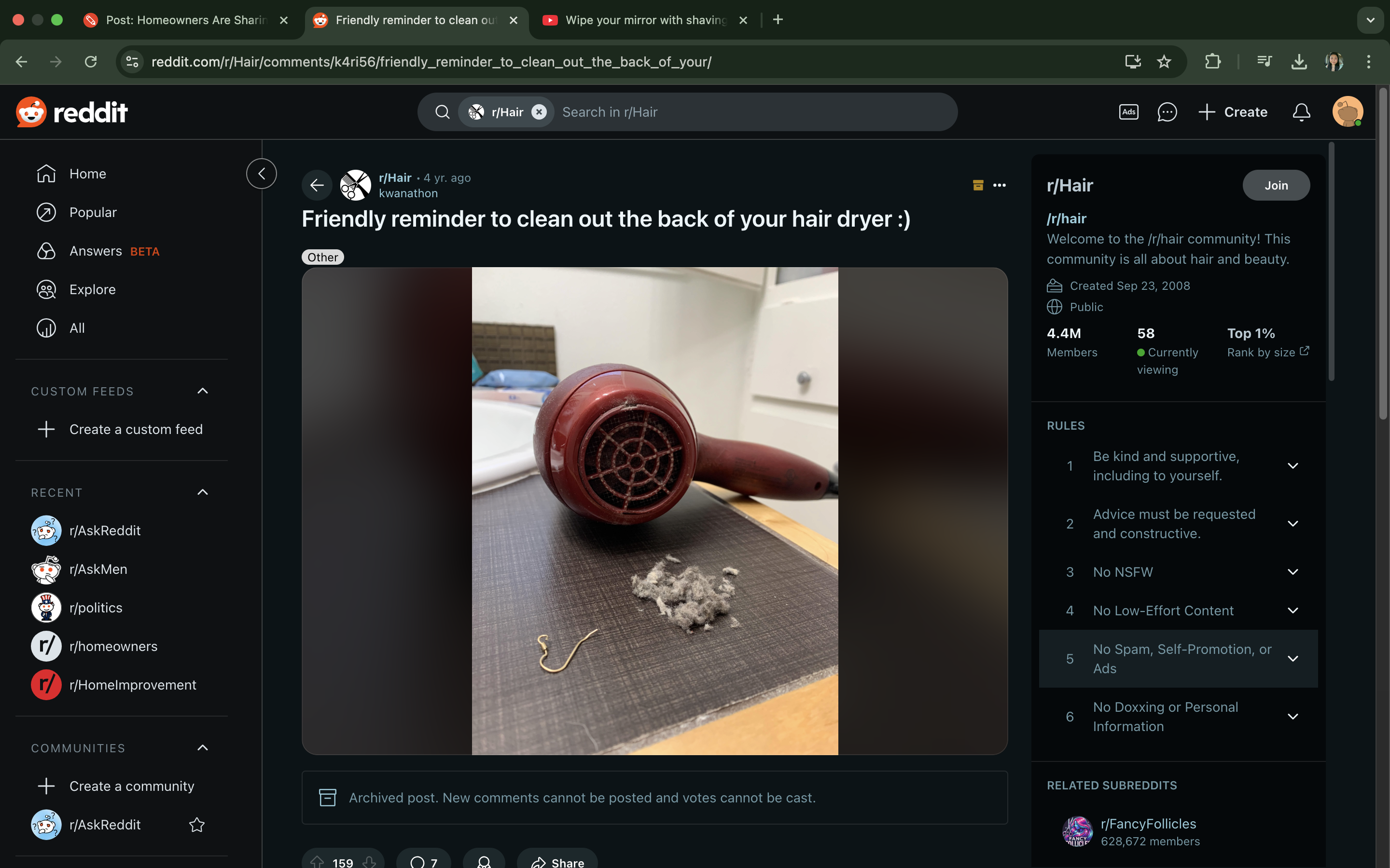 Hair dryer with lint on a table; Reddit post advises cleaning the back of your hair dryer