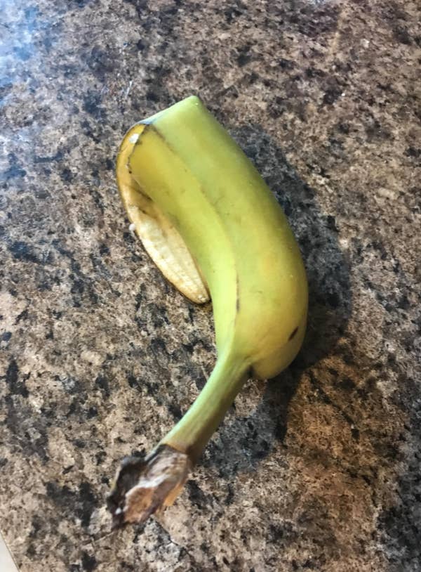 Screenshot of a Reddit post showing a banana peel on a countertop. The post asks if banana peels take extra long to break down, true or false