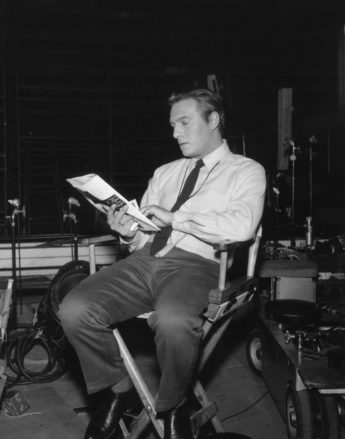 Christopher Plummer seated in a director's chair on the set of "The Sound of Music"