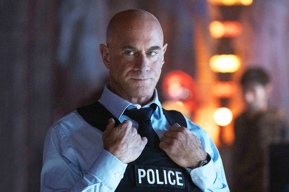 Stabler looking intense while holding the collar of his police vest