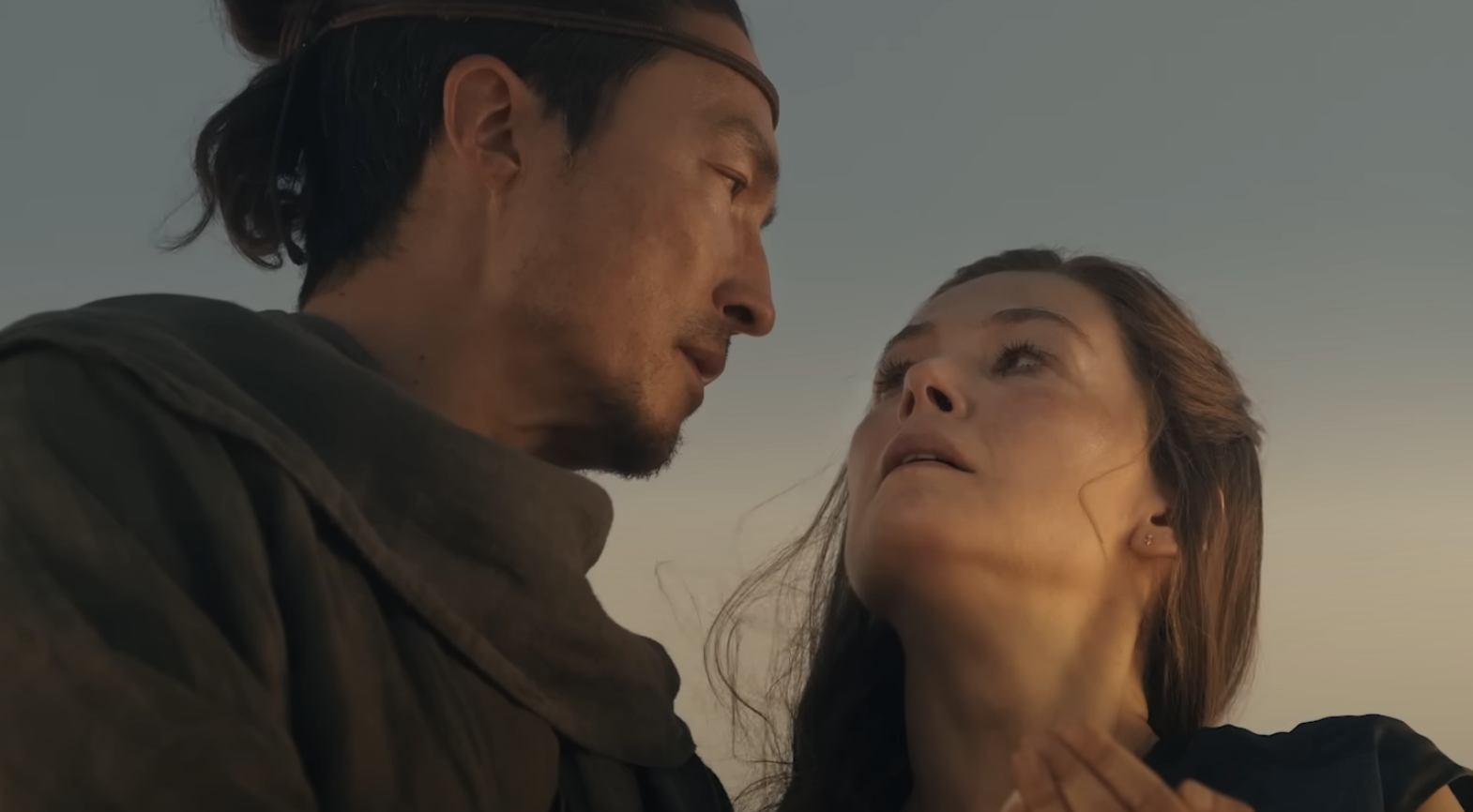 A close-up of Rosamund Pike in a scene from "The Wheel of Time" where she looks longingly in someone's eyes