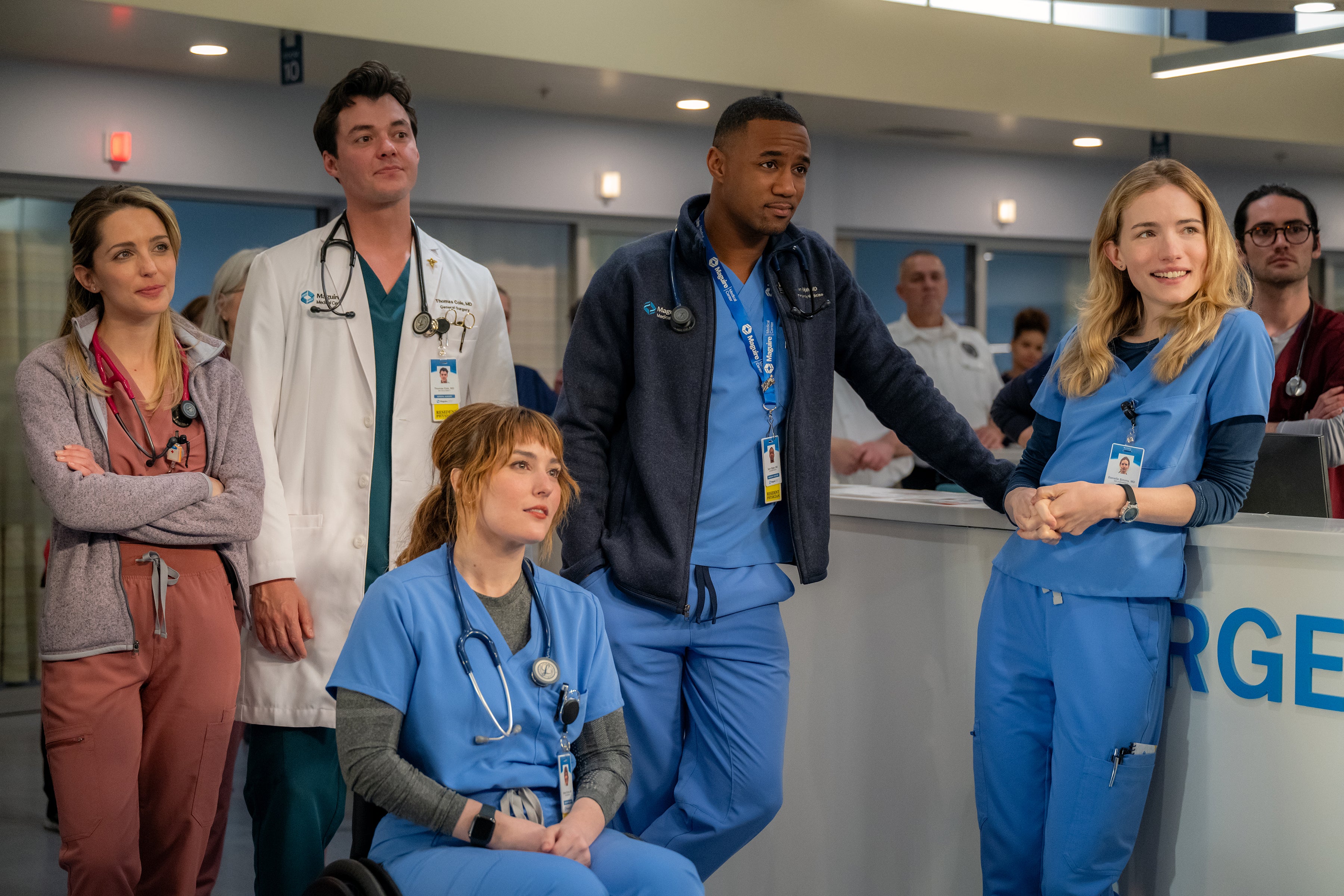 Five doctors wearing scrubs stand in an ER entrance