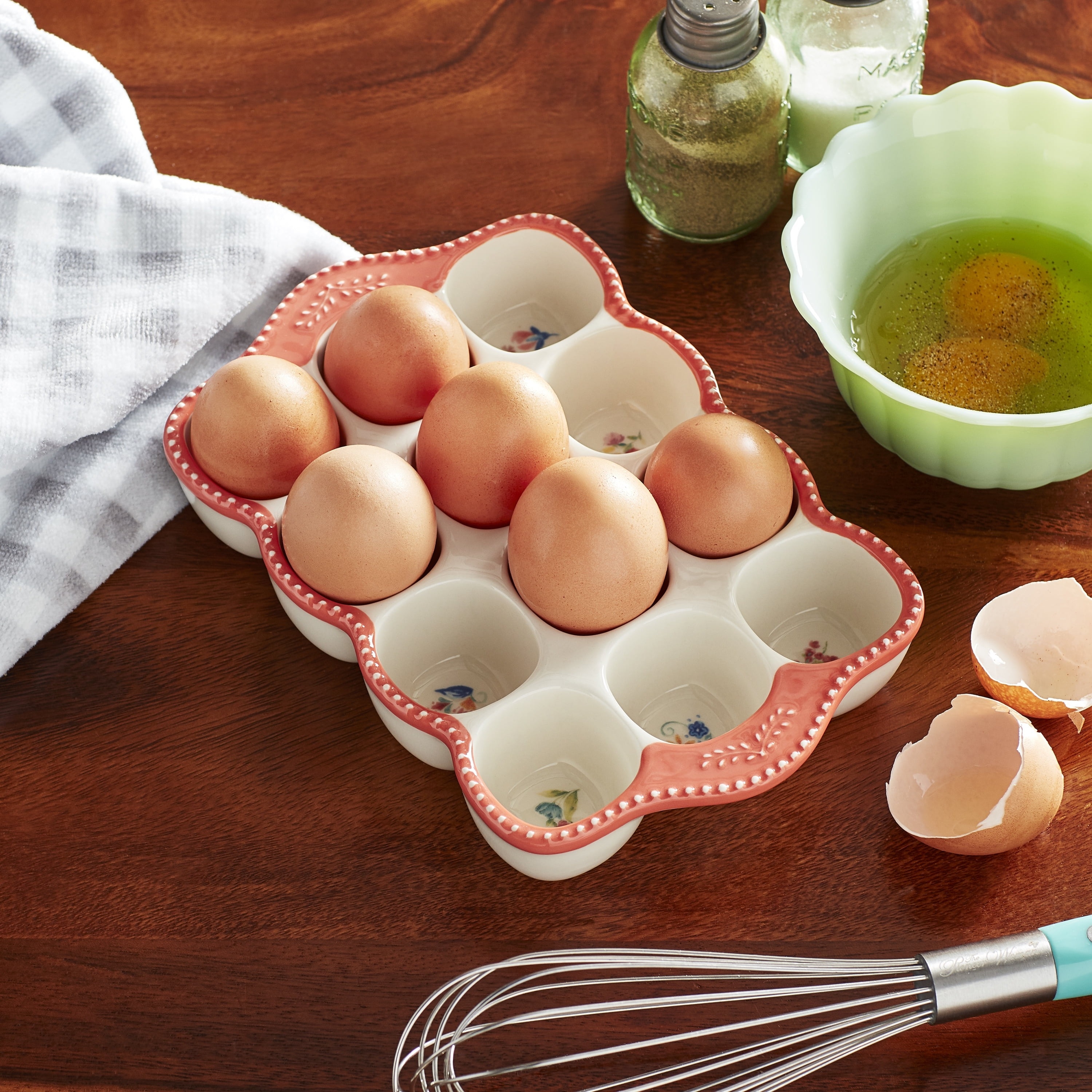 Ceramic egg holder with brown eggs on a wooden table