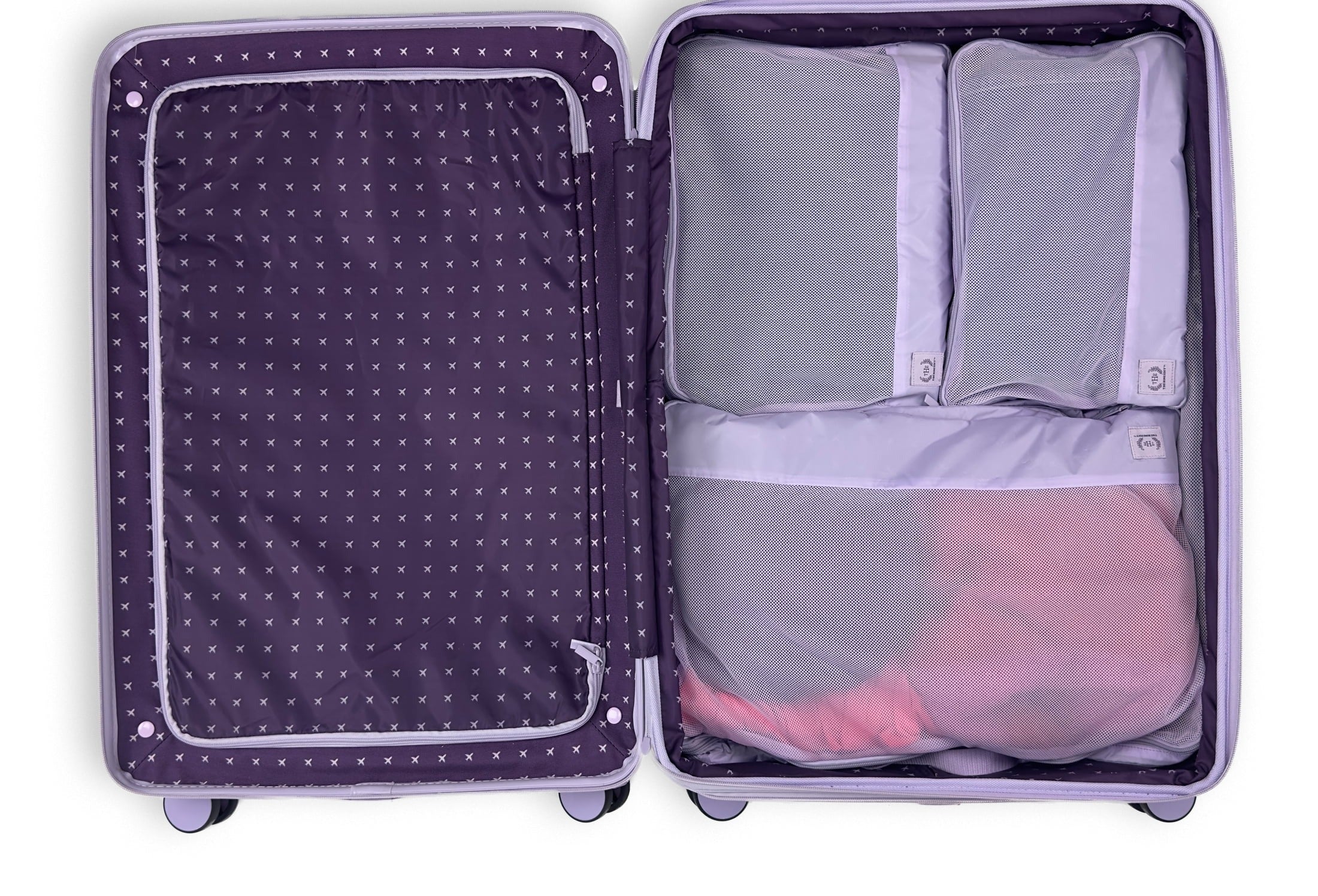 Open suitcase with neatly packed clothing in mesh organizers