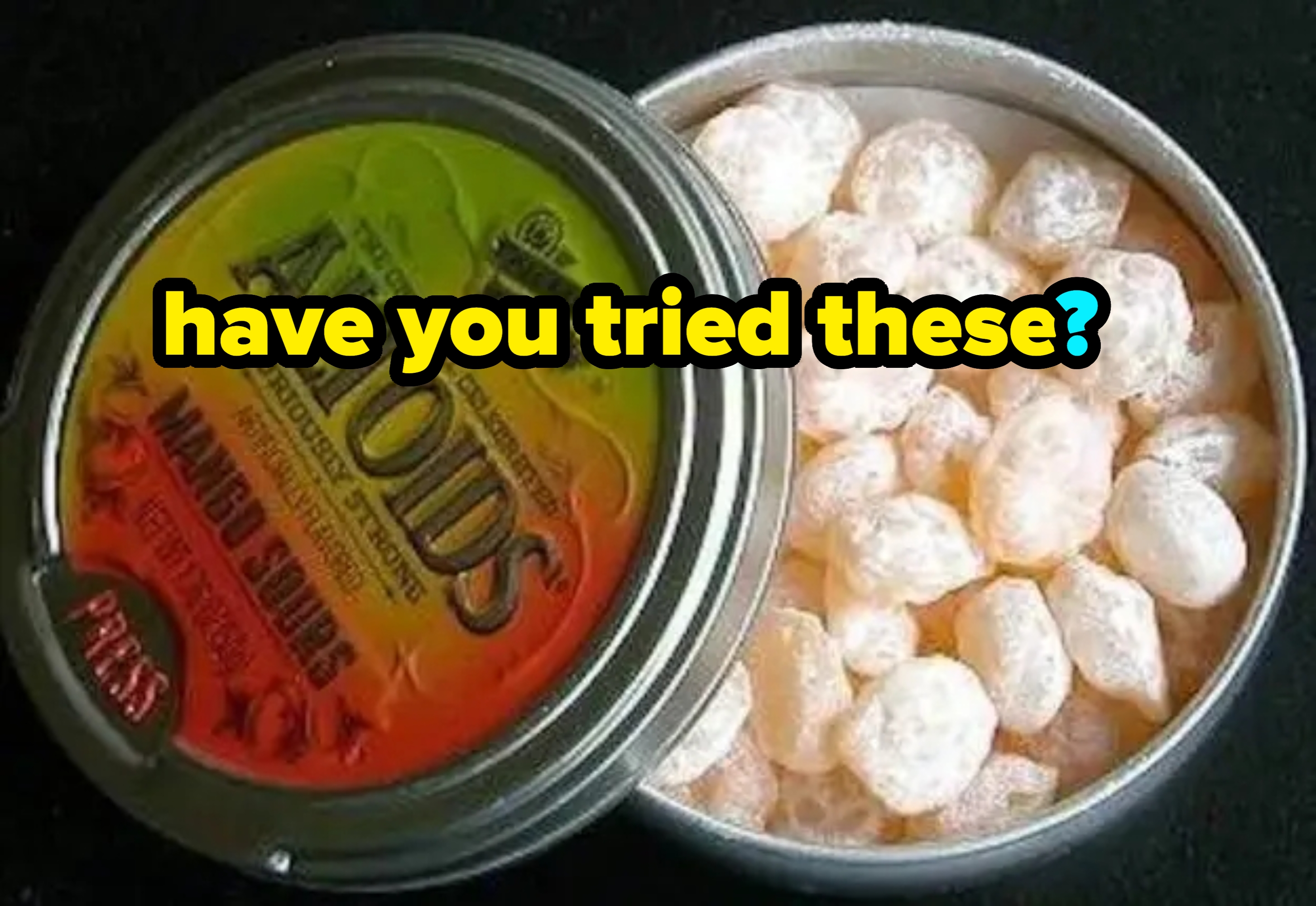 Open tin of Altoids Mango Sours candies, with round white candy pieces visible inside, and a colorful lid displaying the product name
