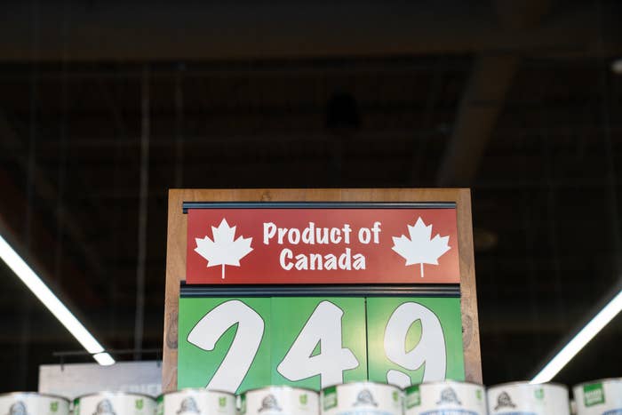 Sign with maple leaves reads "Product of Canada." Price tagged at $2.49, likely for goods below