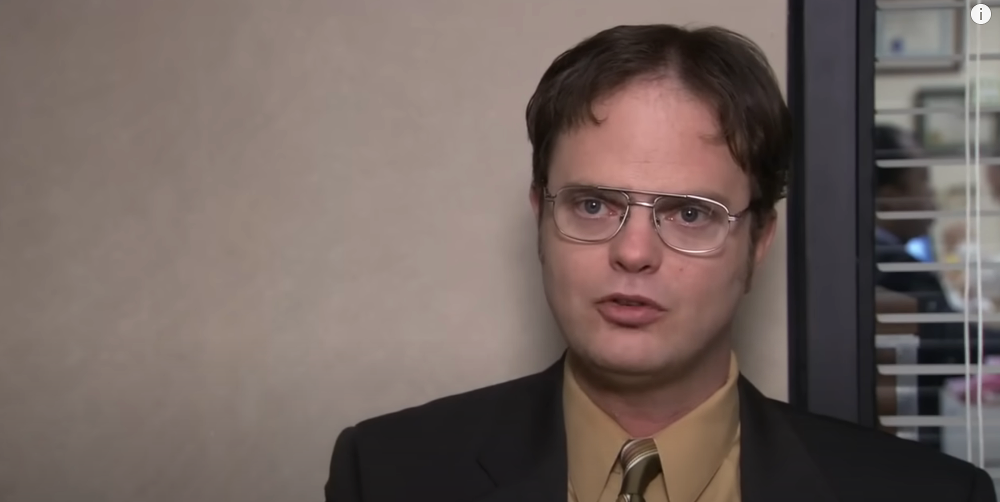 Dwight being interviewed in a scene from &quot;The Office,&quot; looking serious