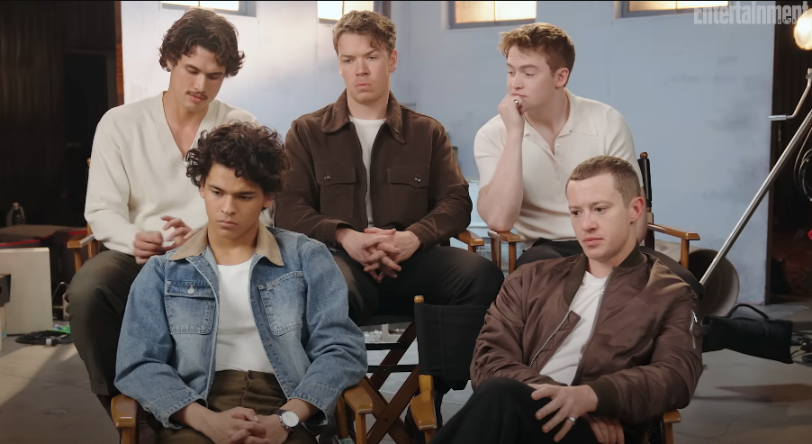 Five young men sit casually in director's chairs during an Entertainment Weekly interview, reflecting on a discussion