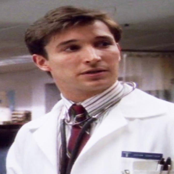 Noah as Dr. Carter in "ER" wearing a white coat and stehescope