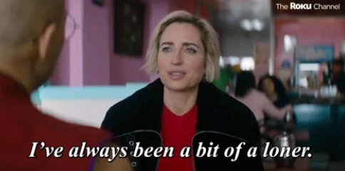 A woman in a cafe setting says, "I've always been a bit of a loner," in a scene from The Roku Channel