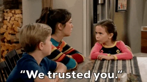 Two children and an adult sitting at a table looking serious. The scene has the text: "We trusted you."