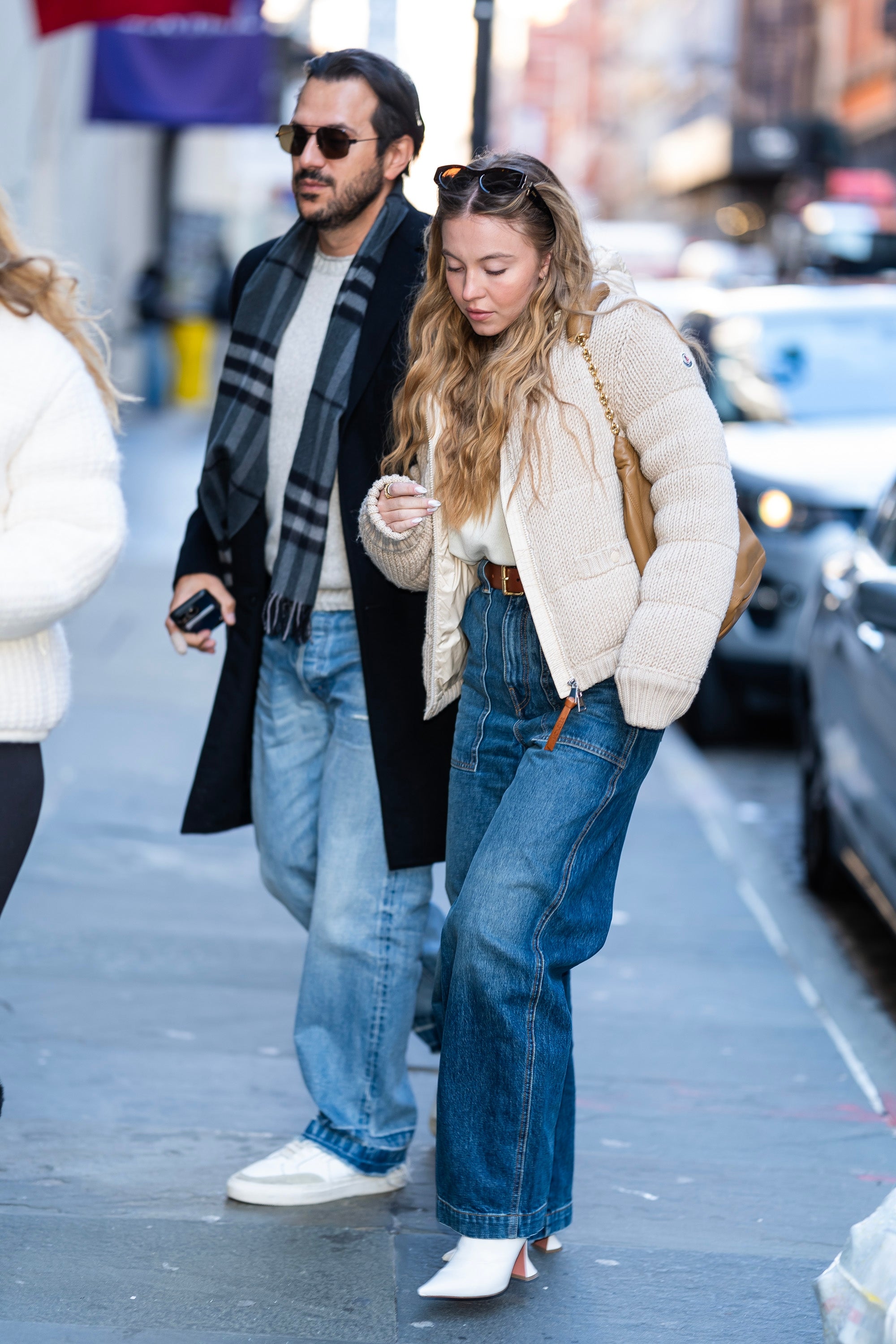Jonathan Davino and Sydney Sweeney walking on a city sidewalk