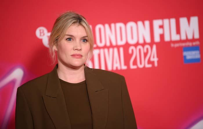 Emerald Fennell on red carpet wearing a brown blazer at the London Film Festival 2024