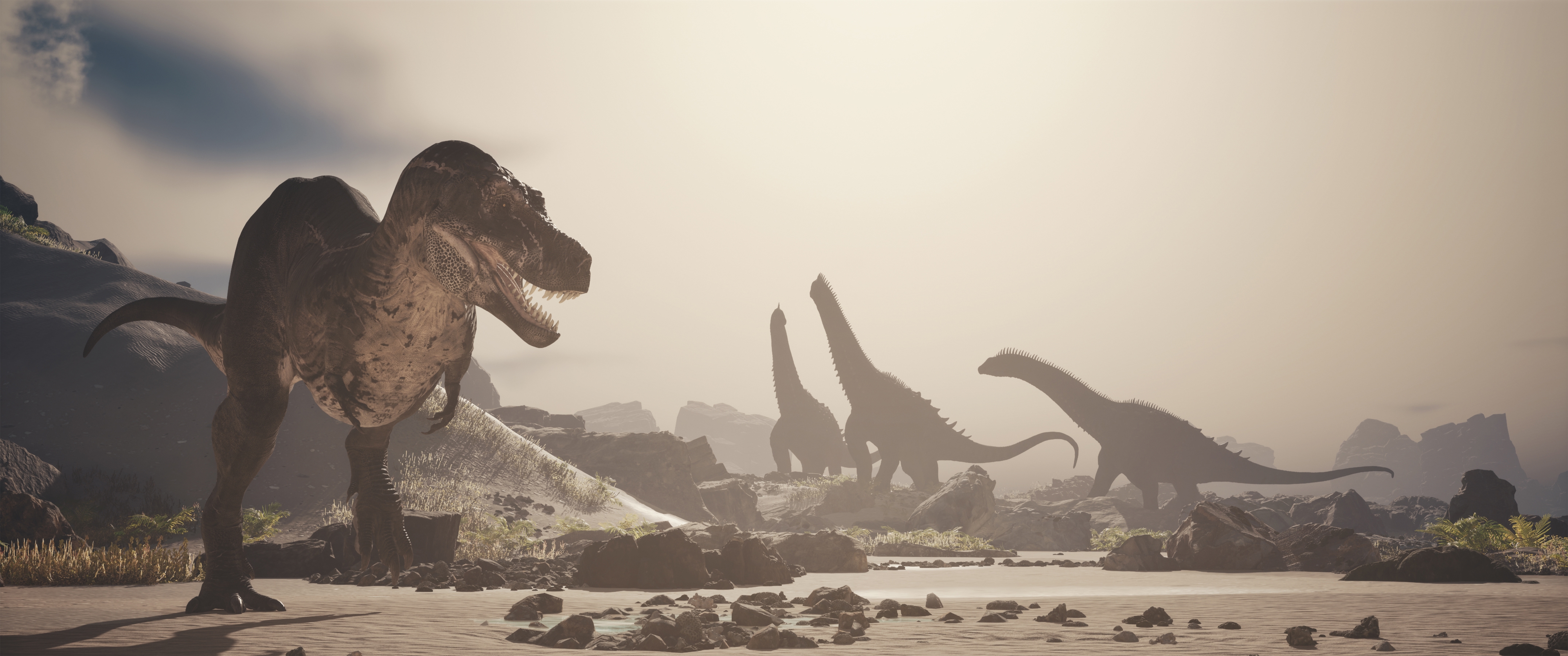 Dinosaurs roam an open landscape with rocks and sparse vegetation, depicting a prehistoric scene