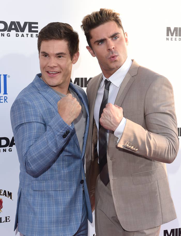 Adam DeVine and Zac Efron posing playfully at a red carpet event