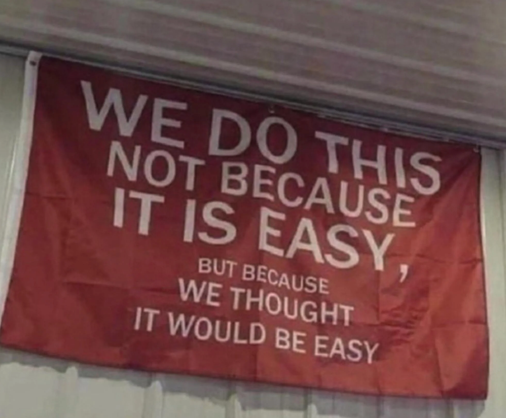 Banner with text: "We do this not because it is easy, but because we thought it would be easy."