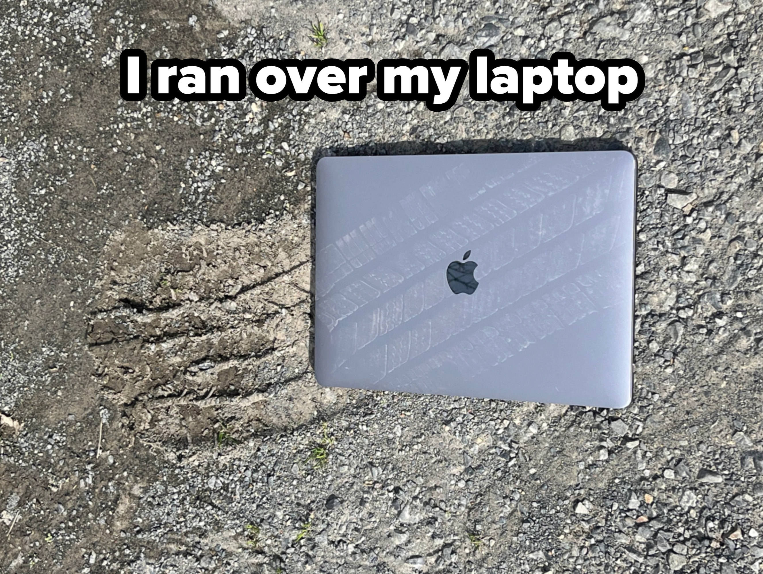 Laptop on a gravel surface reflecting light