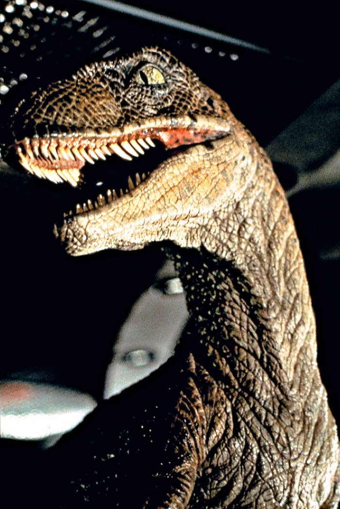 Close-up of a dinosaur with sharp teeth and textured skin, appearing fierce and lifelike