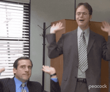 Michael and Dwight raising their arms in excitement in &quot;The Office.&quot;