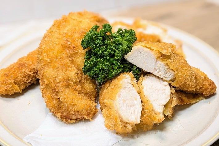 チキンカツの盛り合わせ。切断面が見える2切れと、上にパセリがのっている。