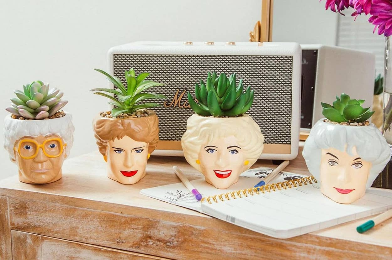 planters in the shape of each of the golden girls faces with faux plants