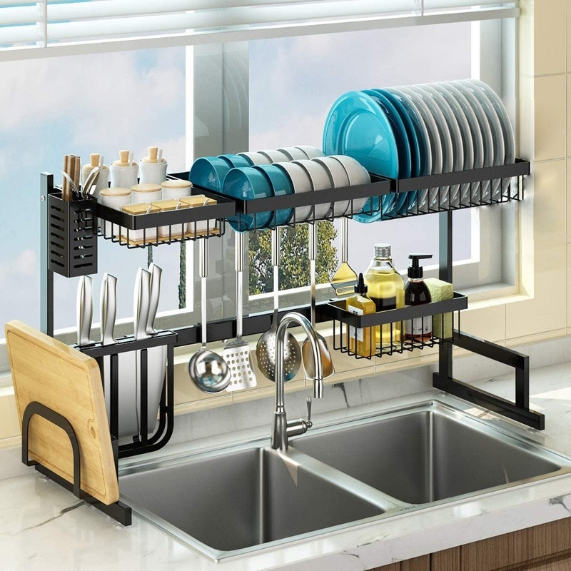 An over-the-sink drying rack with dishes and other kitchen essentials