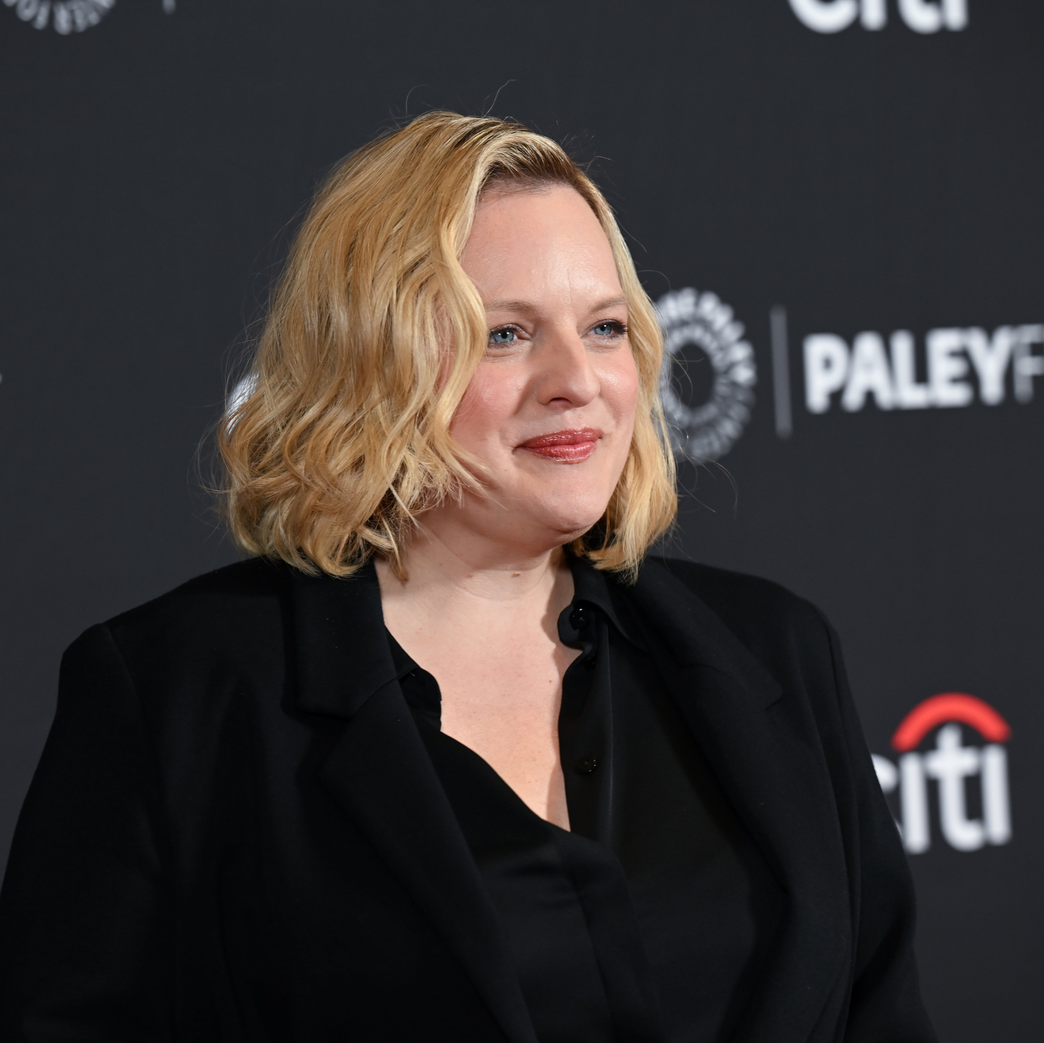 Elisabeth Moss on a red carpet, smiling