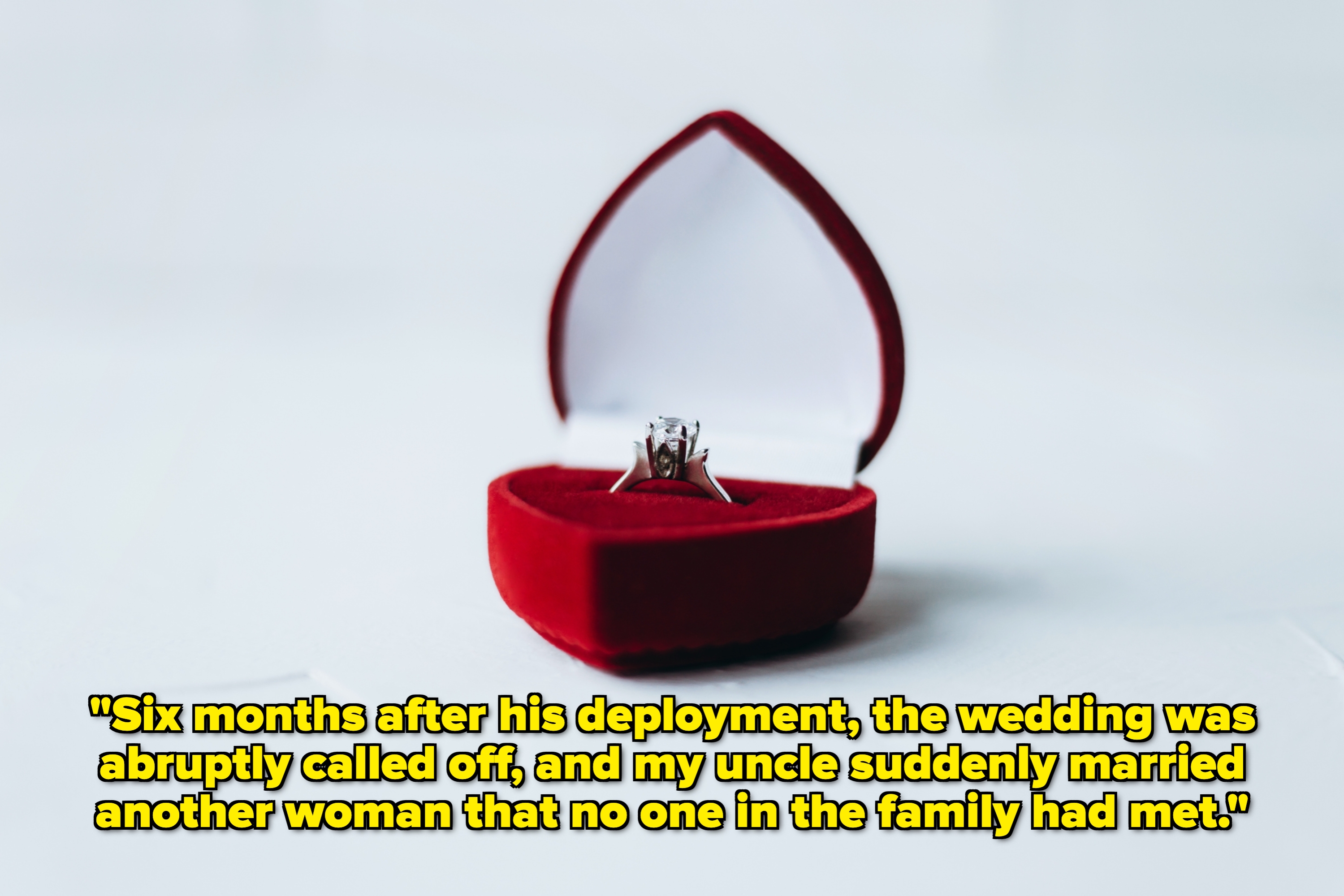 A heart-shaped ring box is open, showcasing a diamond engagement ring inside