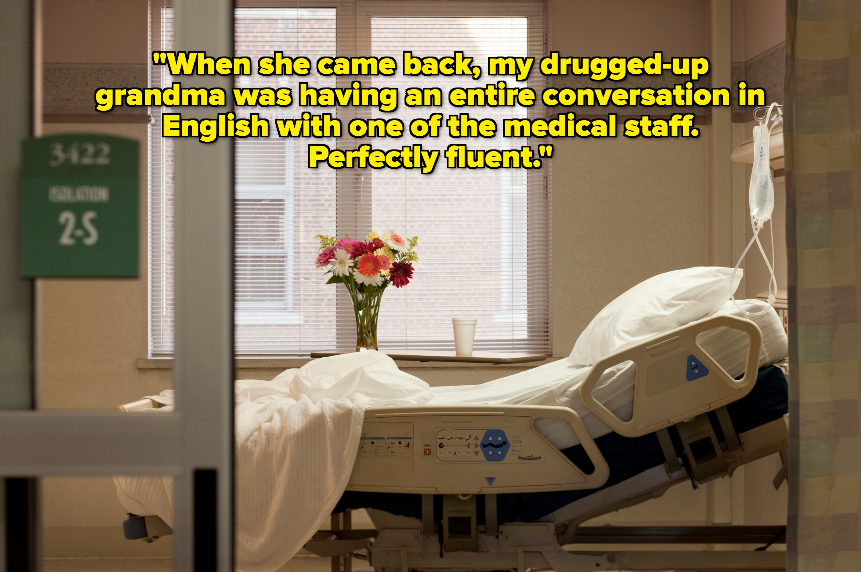 Empty hospital room with a single bed, vase of flowers, and IV stand near a window