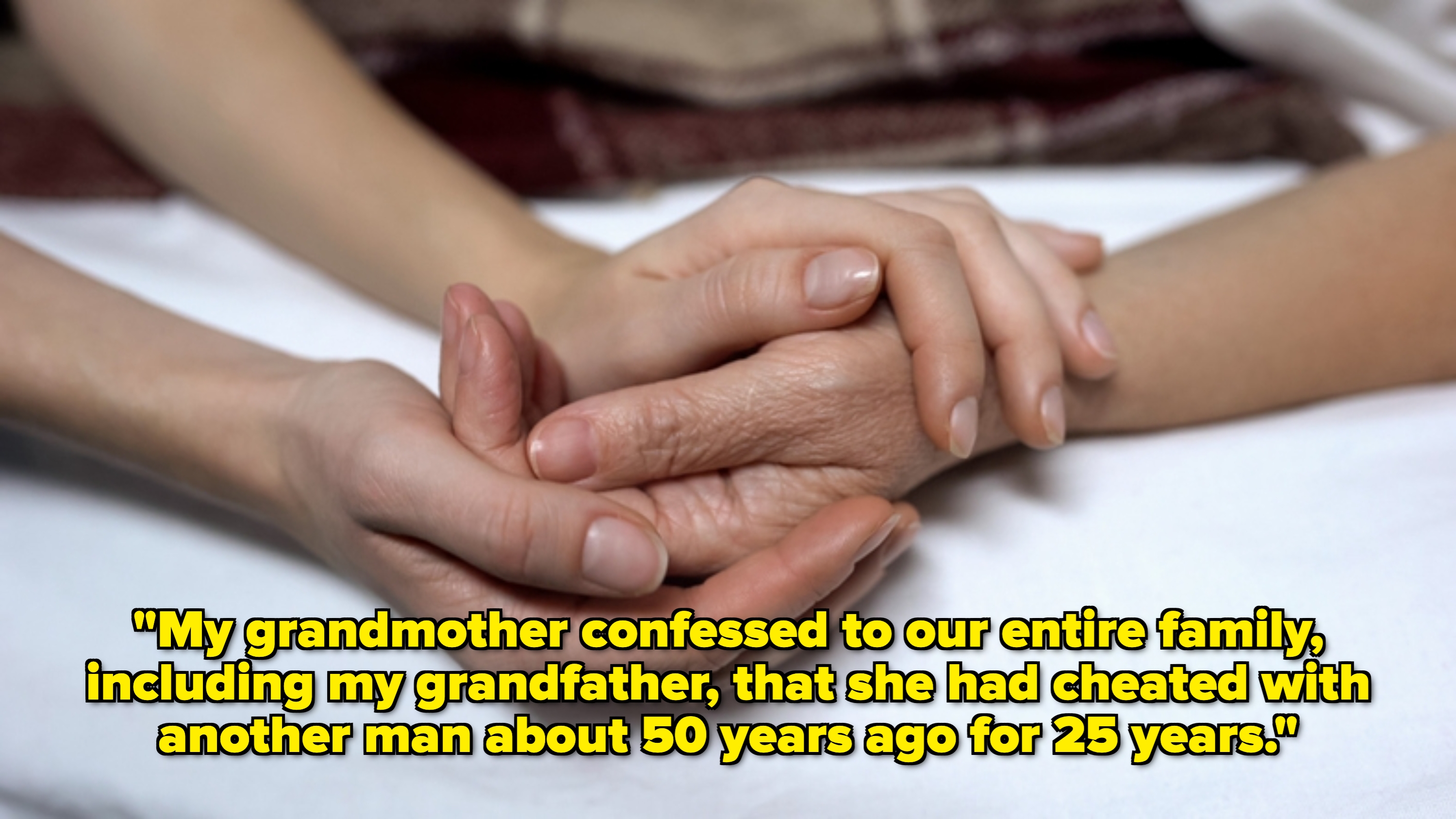 Hands gently holding one another on a bed, conveying support and care