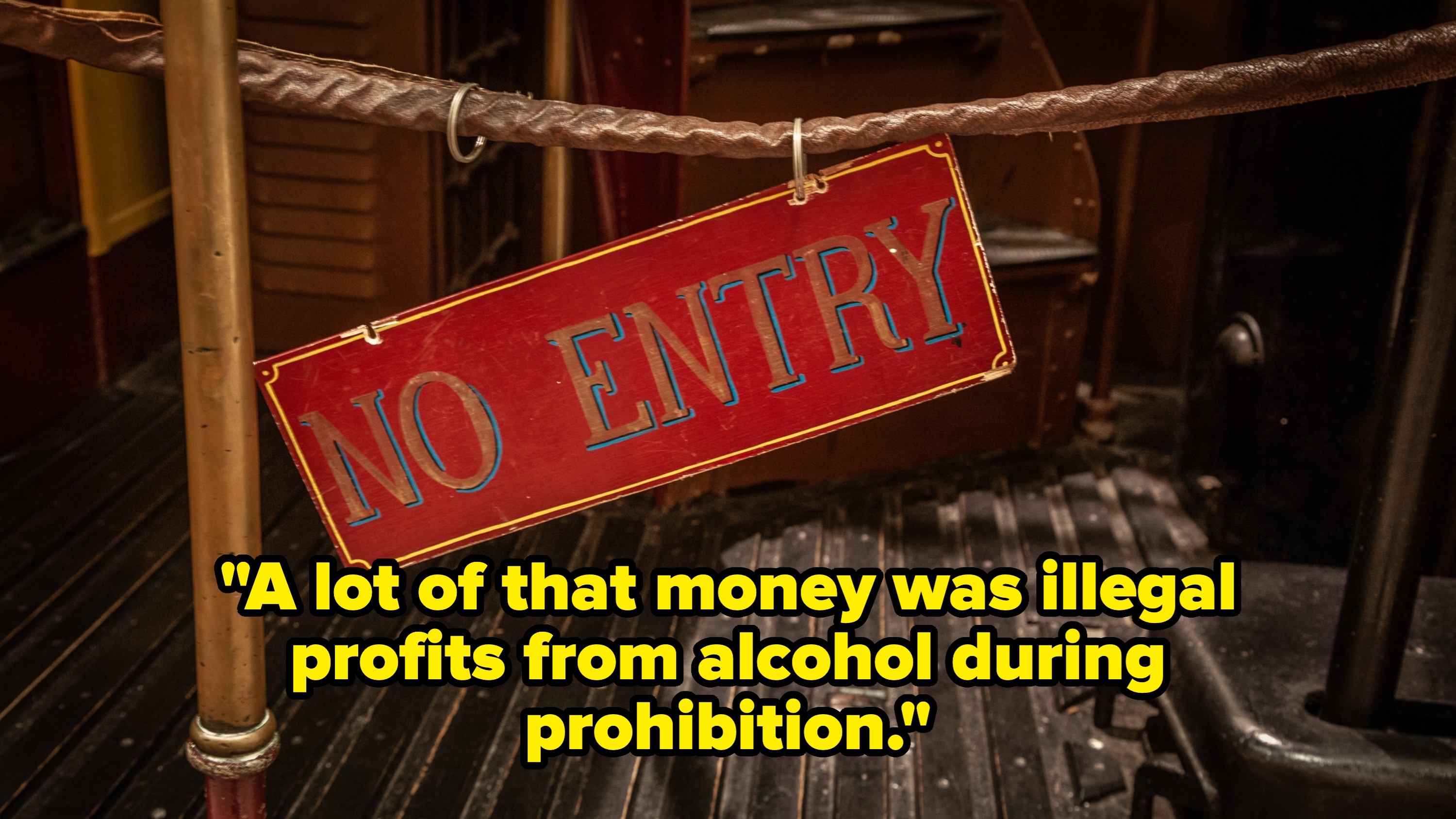 Sign reading "No Entry" hanging by a rope, set against a vintage-style backdrop, suggesting restricted access