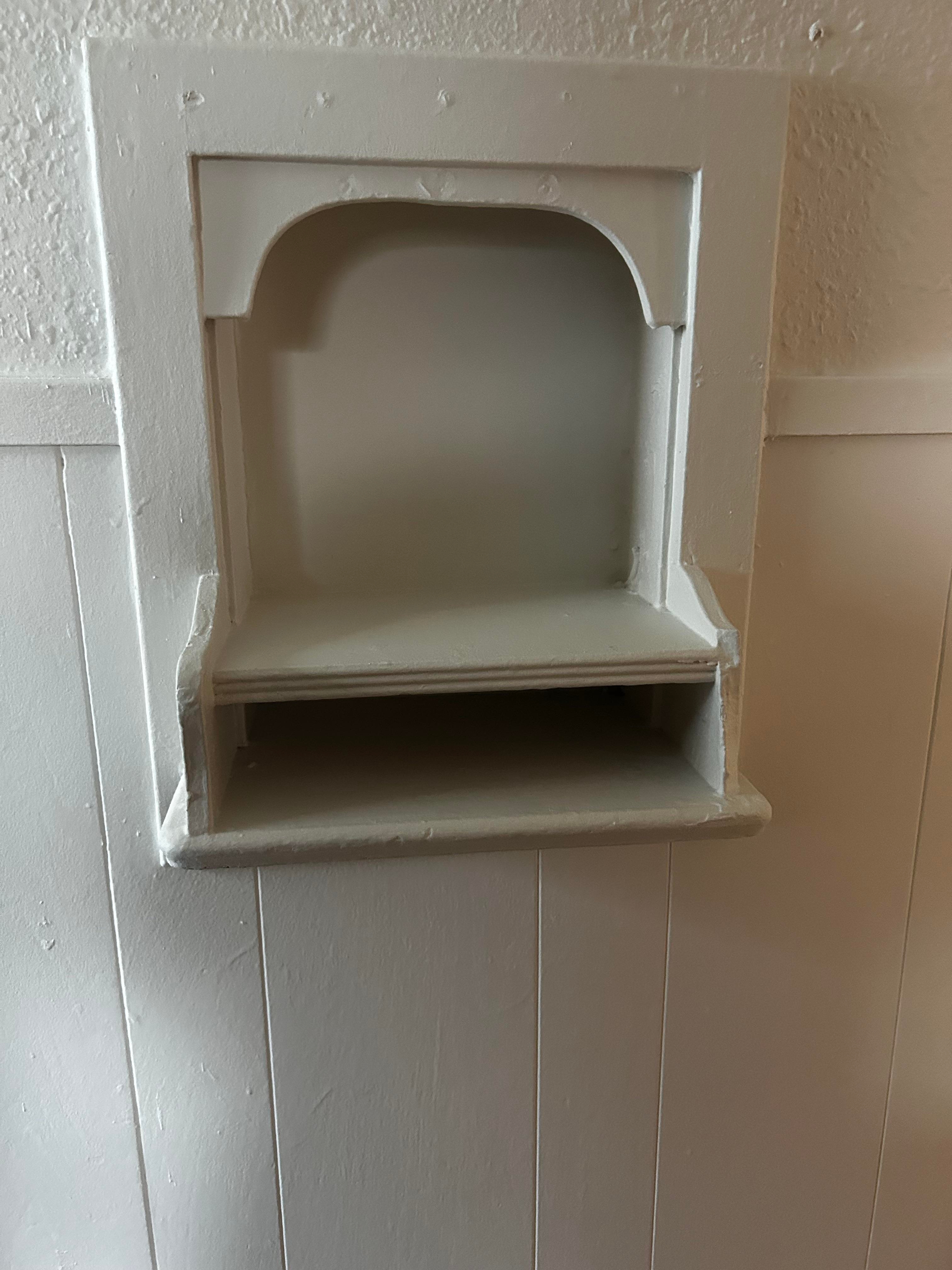 Wall nook with a small built-in shelf, recessed into the wall, possibly used for decor or storage