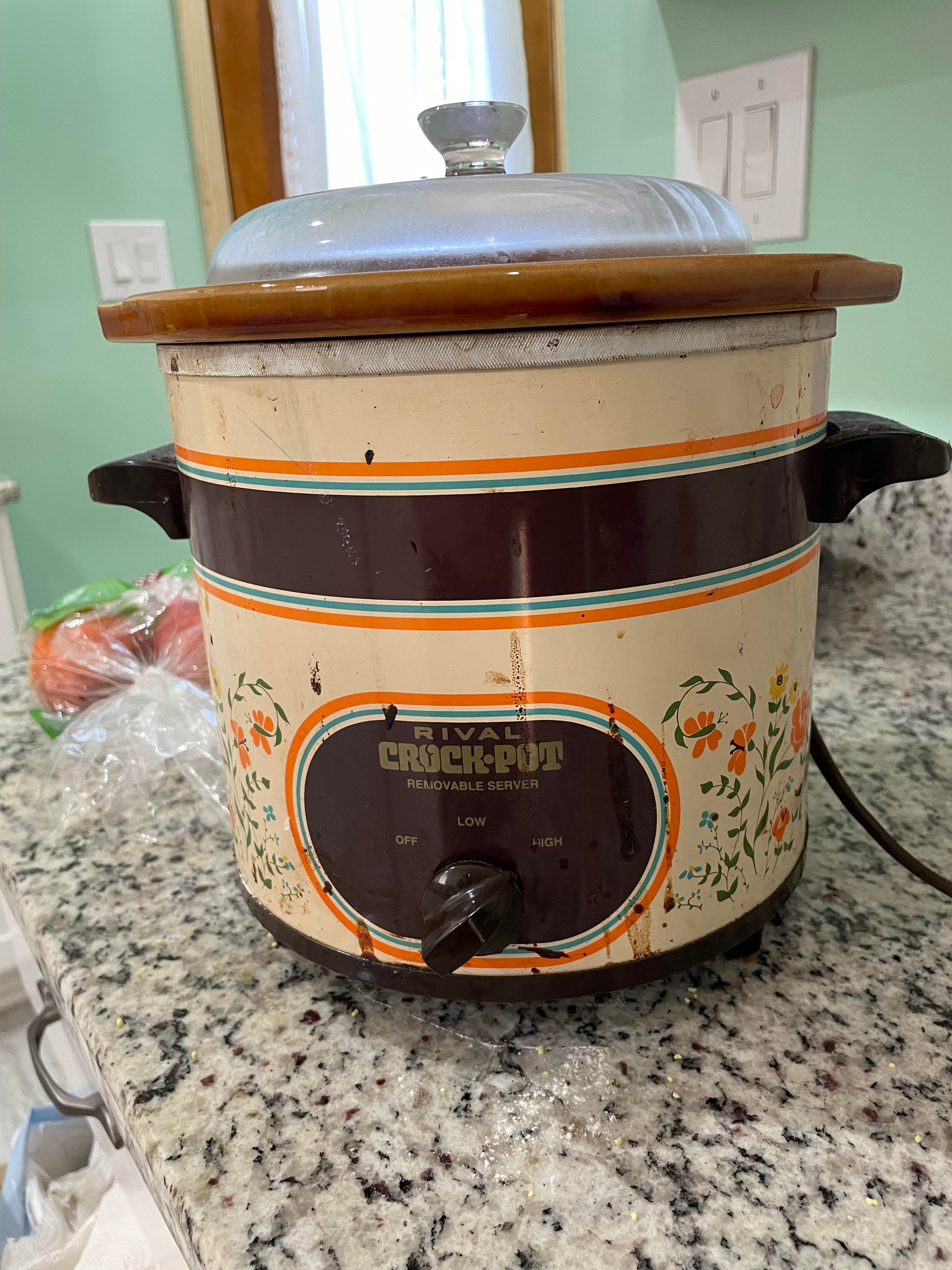 Vintage Crock-Pot with floral design on a granite countertop, set between off, low, and high settings
