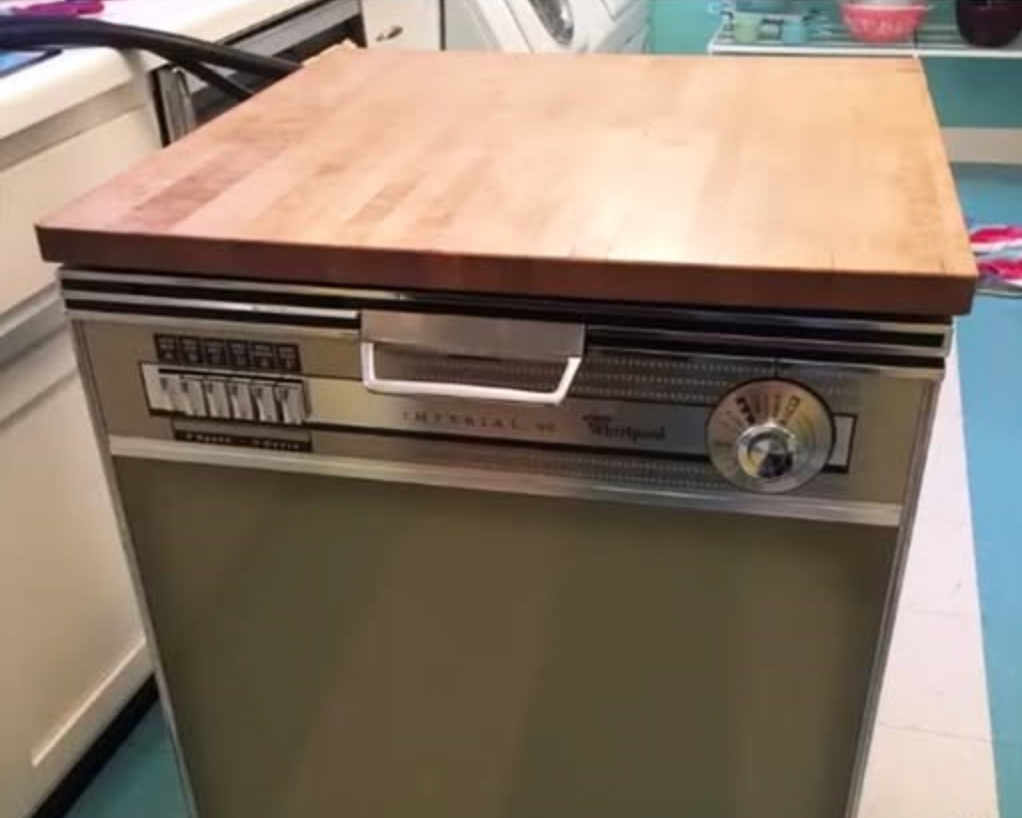 Vintage portable dishwasher with a wooden countertop and control panel, featuring buttons and a dial