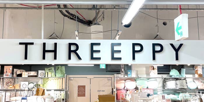 店の入口にある「THREEPPY」の看板。背景に商品棚が見える。