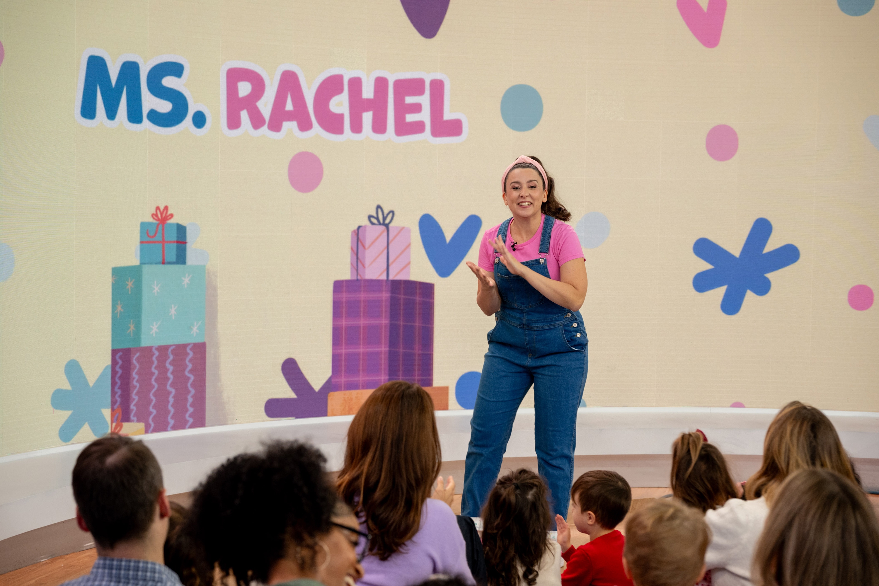 Ms. Rachel entertaining a group children on stage
