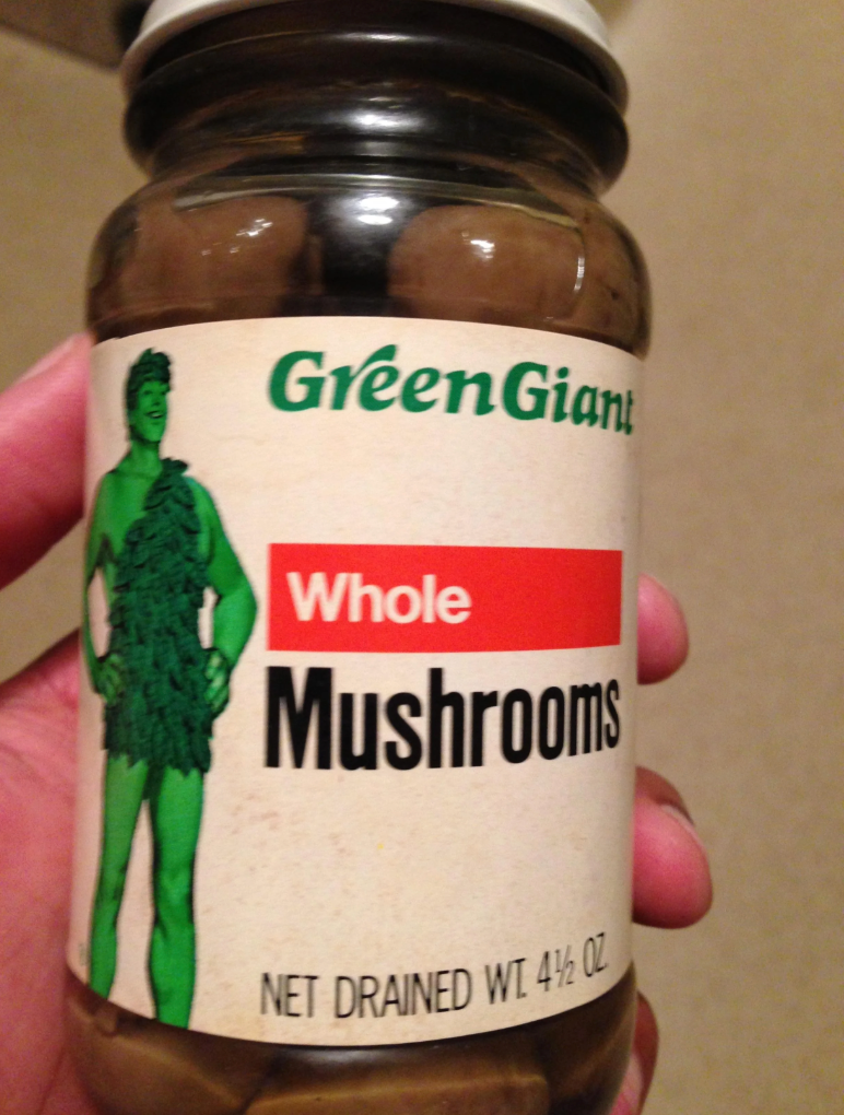 Jar of Green Giant whole mushrooms with a label showing the Green Giant mascot