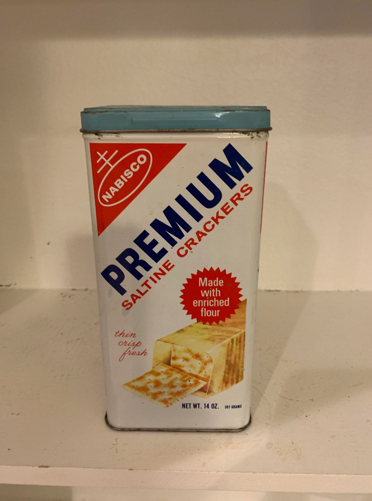 Vintage Nabisco Premium Saltine Crackers tin with branding and product details displayed