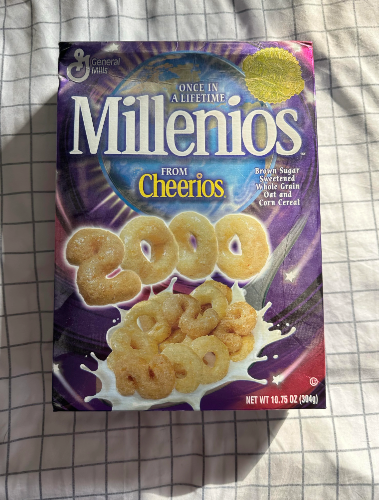 Cheerios cereal box with "Millenios" label, featuring the year 2000 made from cereal pieces and a splash of milk