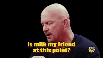 Bald man in a black shirt sits and speaks. Text: "Is milk my friend at this point?"