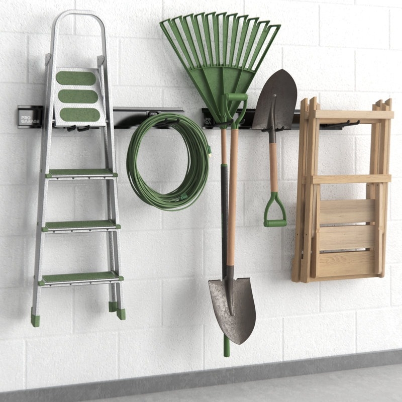 Ladder, hose, rake, shovel, and folding chairs neatly organized on a garage wall-mounted storage system