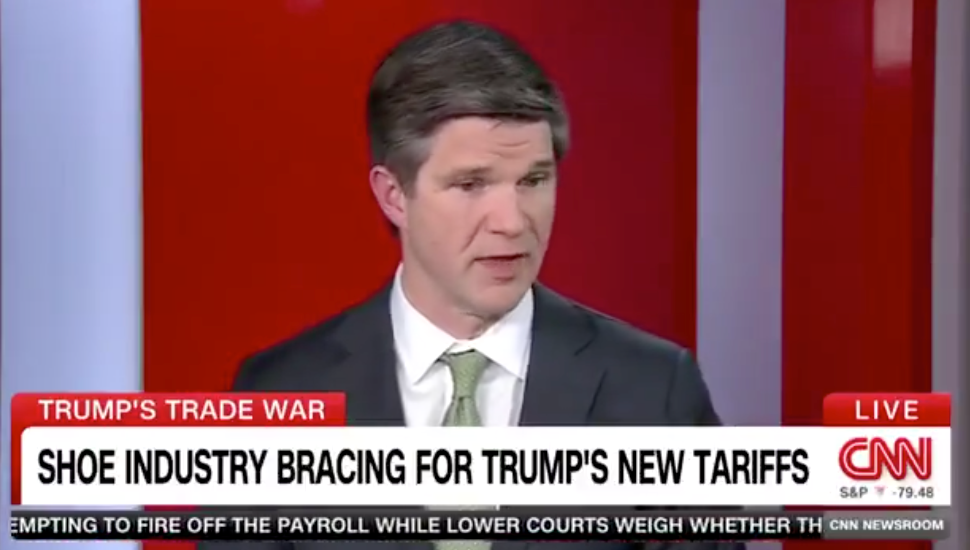 Man in suit discussing shoe industry impact from new tariffs on a CNN segment titled "Trump's Trade War."
